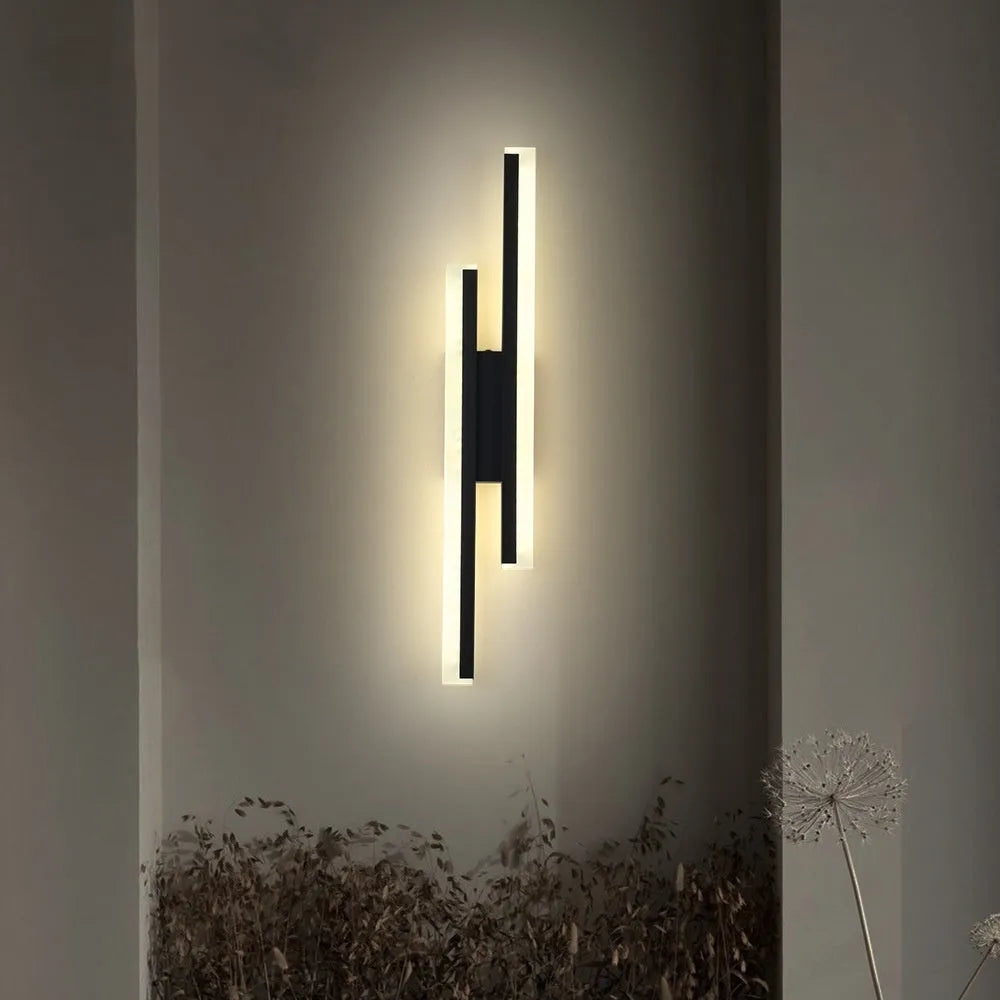 Gold-finish 500mm long double line wall lamp with LED light on a modern wall.