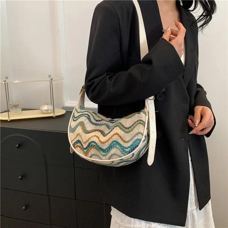 Women's woven straw crossbody bag showing internal phone pocket and file compartment