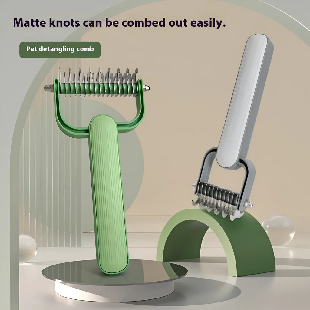 Green and grey dog hair unknotting comb with stainless steel teeth on a plastic handle.