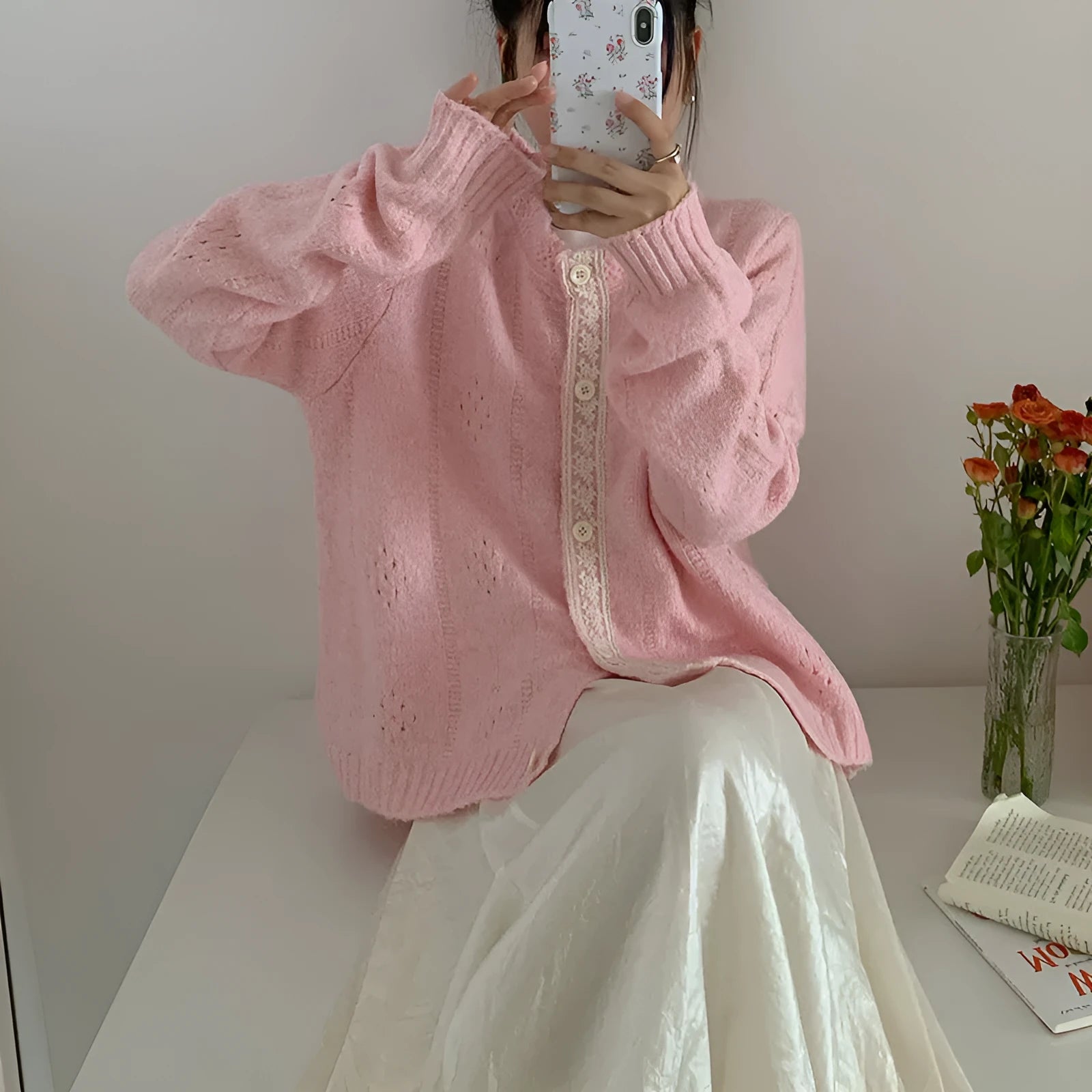 Loose apricot-coloured Korean-style cardigan sweater coat with regular sleeves on a hanger.