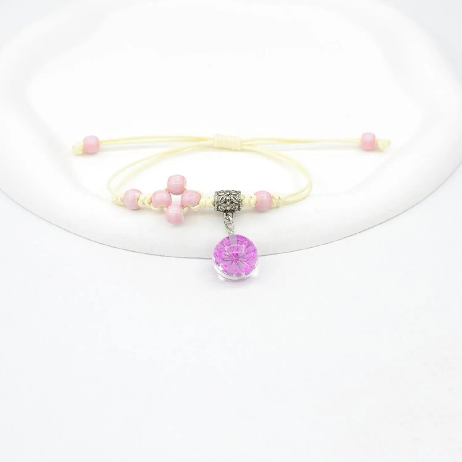 Glass dried flower bracelet with large 1.4 cm beads containing real preserved flowers in hand-woven lace design