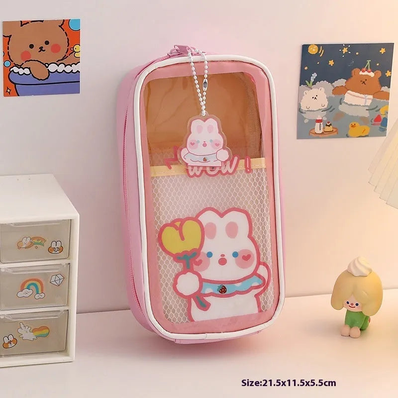 Transparent PVC pencil case with cartoon pattern, showing large capacity design for stationery storage