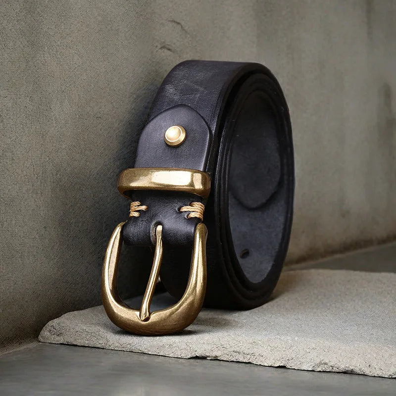 Men's brown casual leather belt with copper pin buckle on a jeans background.