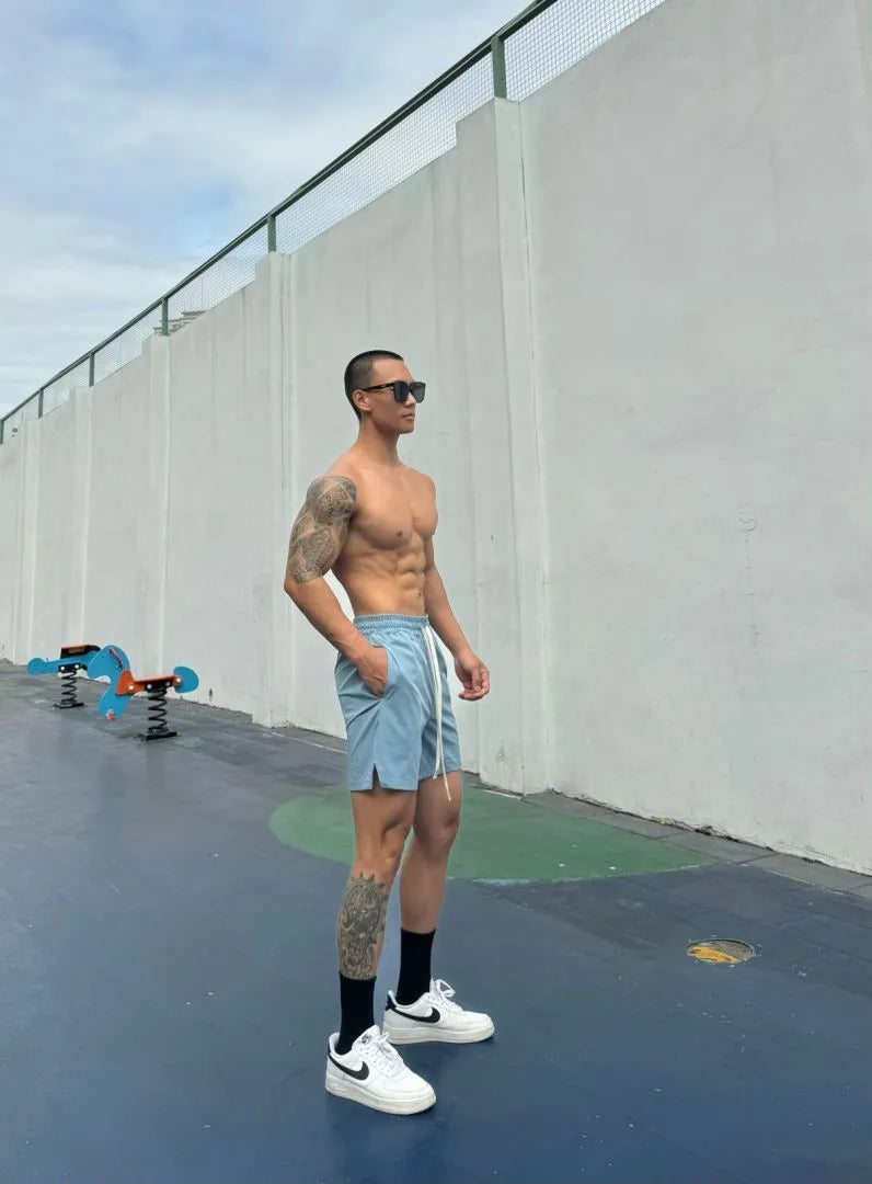 Man wearing grey ice silk quick-drying double-layer quarter shorts on a casual day out.