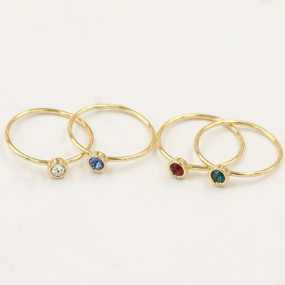 Women's 14K gilded GF zircon knuckle ring shown in green, blue, dark red, and white on a sizing chart.