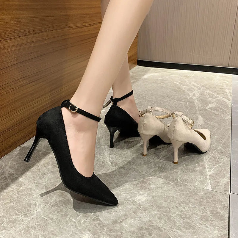 Women's black stiletto heel pump shoe with a buckle detail on the upper