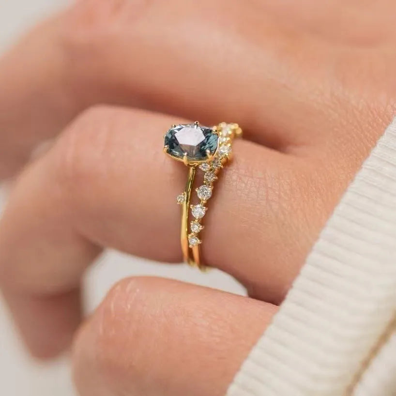 Gold plated flower ring with green zircon stones on display