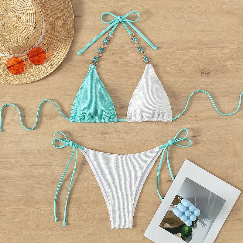 Women's colour-matching bikini with lace-up front and pearl chain decoration, sleeveless top and shorts set.