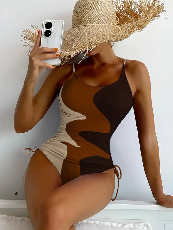 Women's sleeveless one-piece swimsuit in a striped print, showing backless design and available in multiple colours.