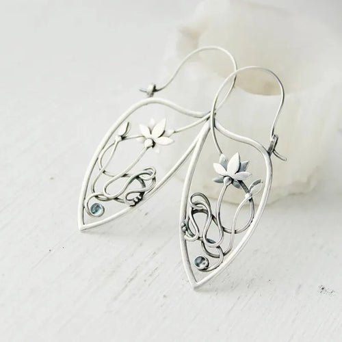 Silver lotus flower earrings with geometric shapes and rhinestone details