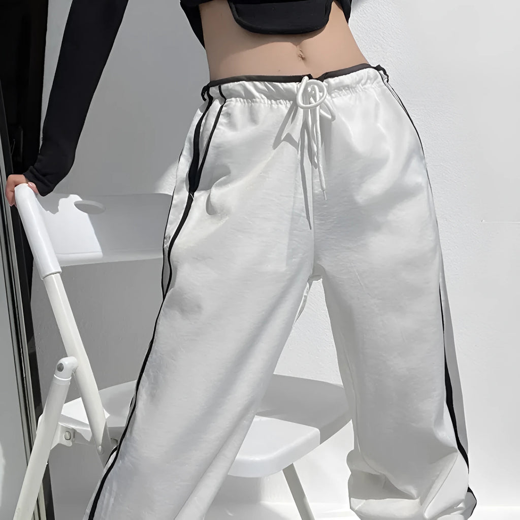 Women's straight leg trousers with ribbon waist and parallel bars contrast detailing in navy blue
