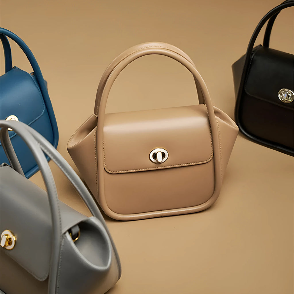 Women's leather wing-shaped tote bag with hard handle and cross-body strap in four colour options