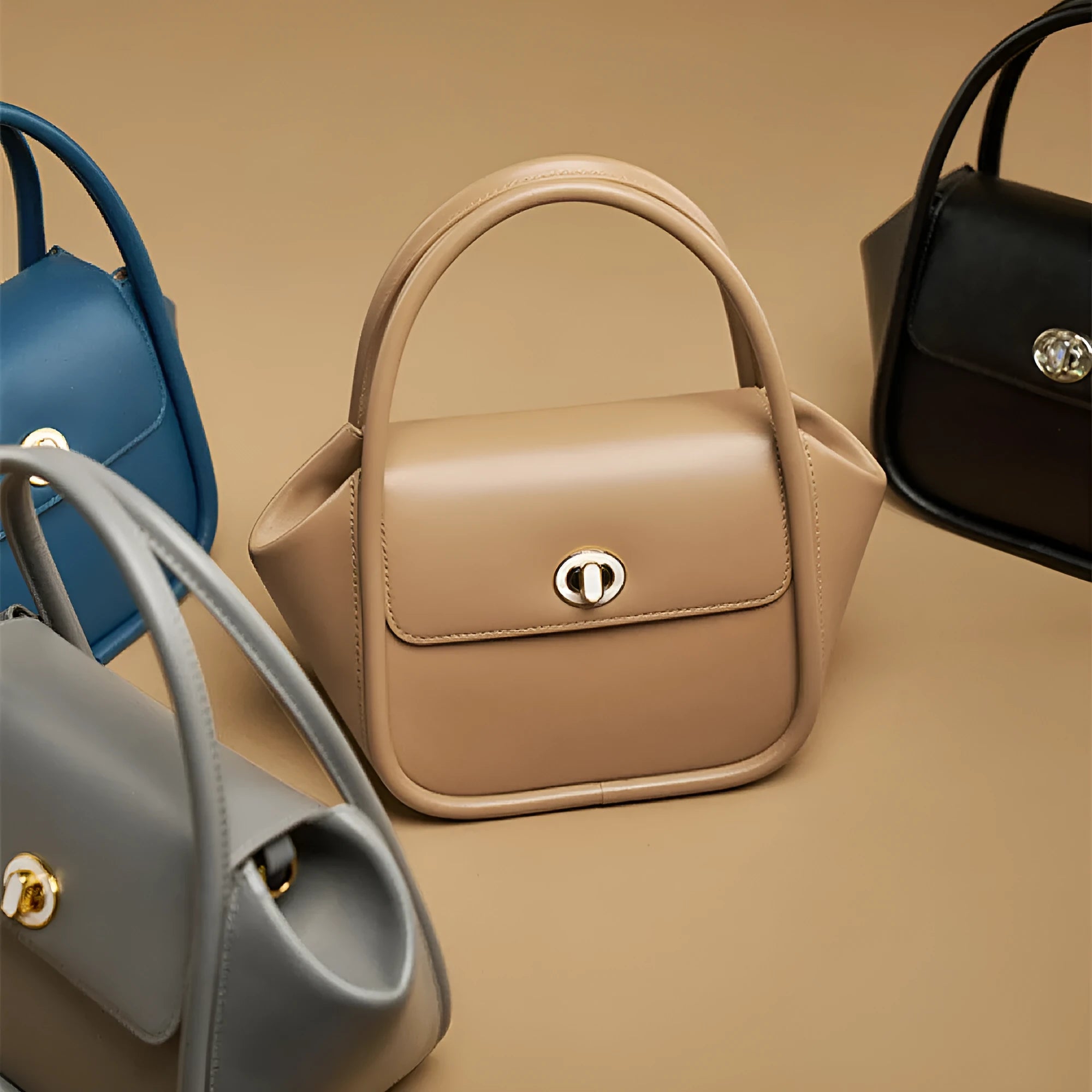 Women's leather wing-shaped tote bag with hard handle and cross-body strap in four colour options