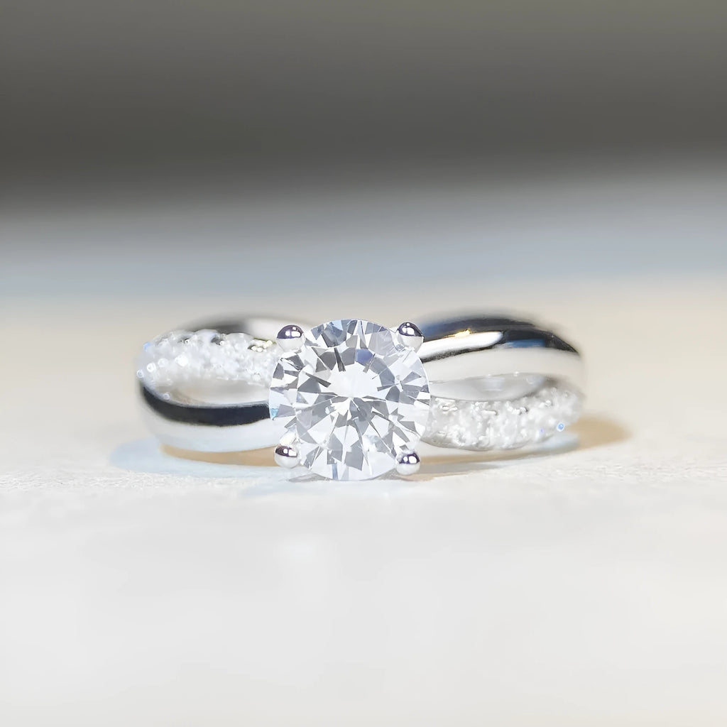 Geometric silver ring with 1 karat moissanite stone in four-claw setting and twisted arm winding band