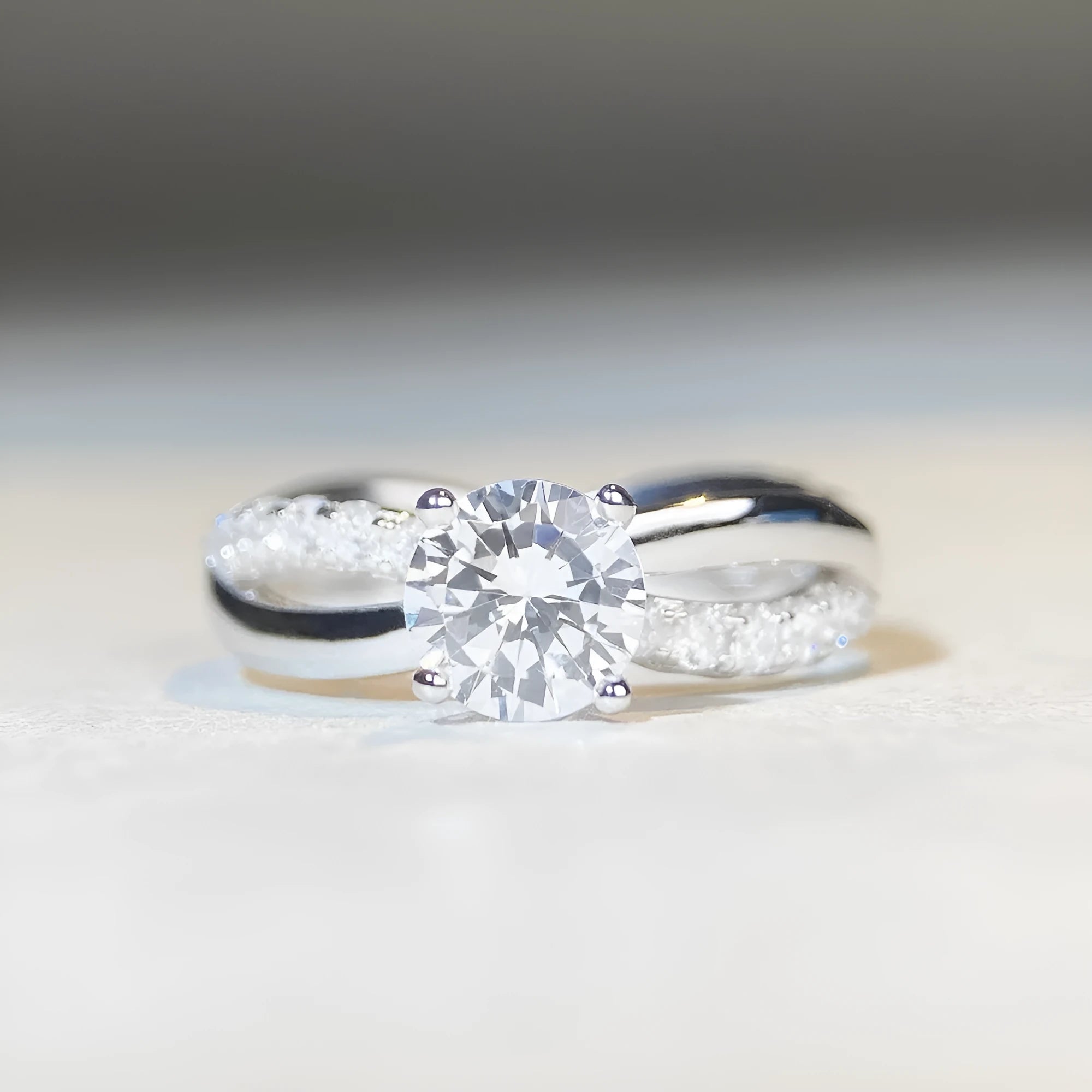 Geometric silver ring with 1 karat moissanite stone in four-claw setting and twisted arm winding band