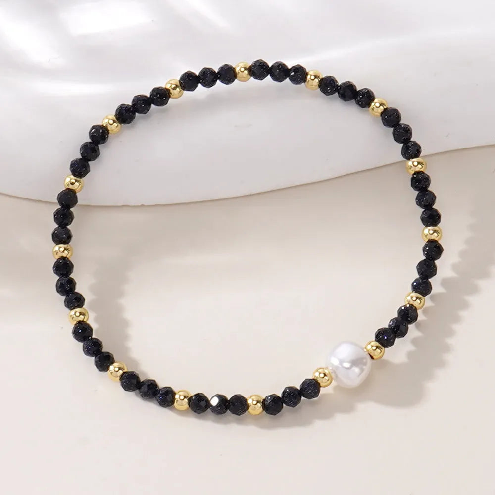 A geometric natural stone bracelet with an ellipse detail, shown in one of fifteen available colour options.
