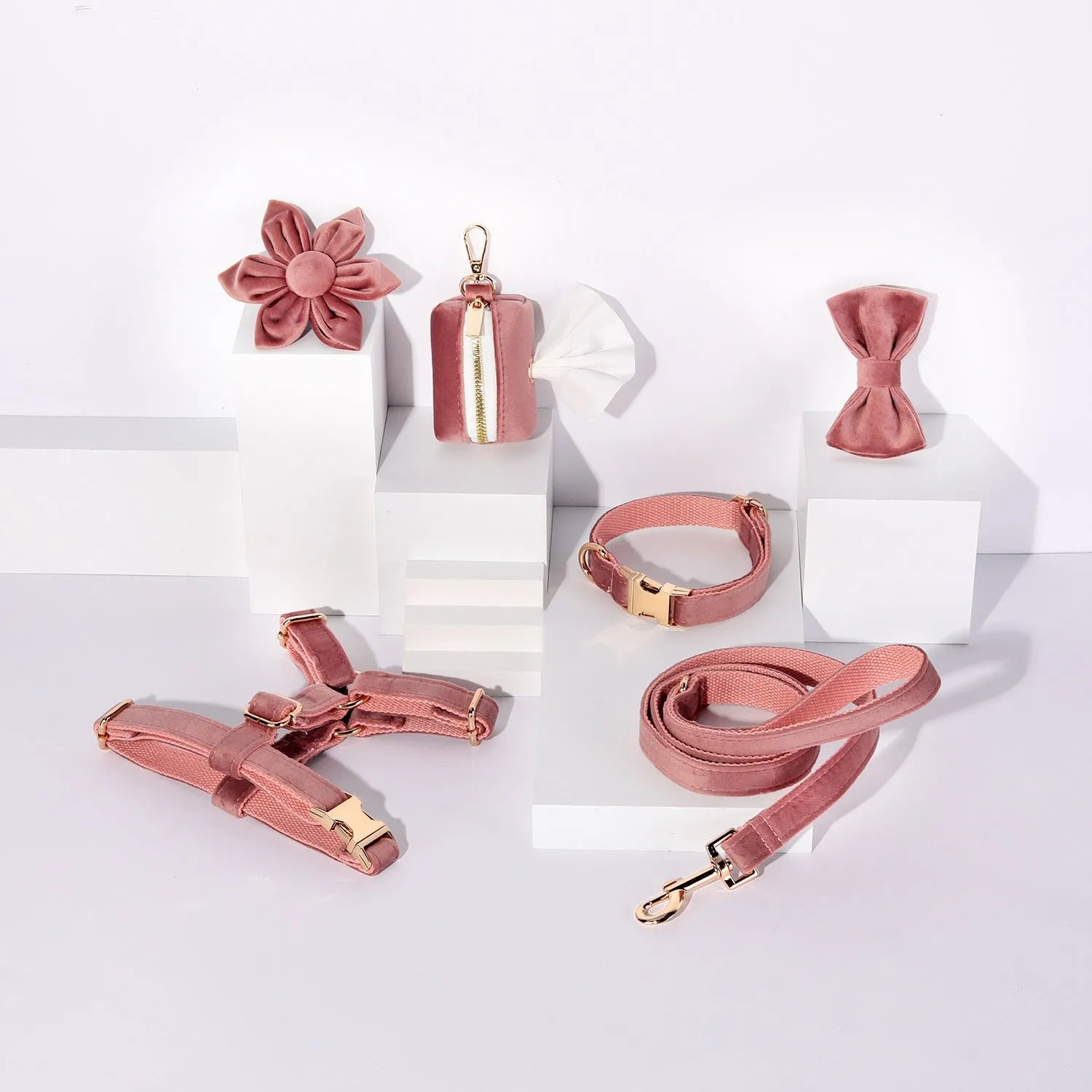 Classic velvet dog harness and lead set in red fleece with attached bow tie and waste bag holder.