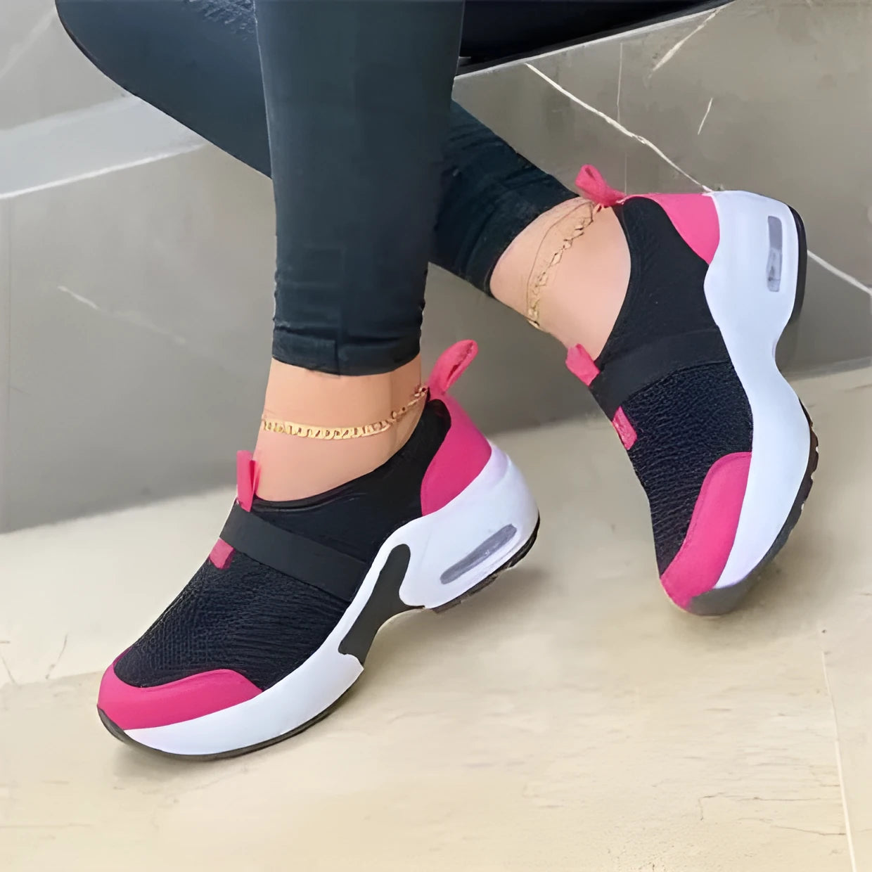 Women's flat sneakers in light grey with mesh upper, round toe, and rubber sole.