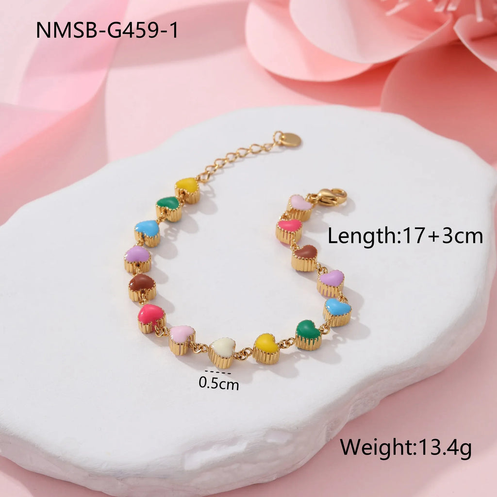 Close-up of a women's love heart-shaped bracelet in stainless steel with 18K gold plating.
