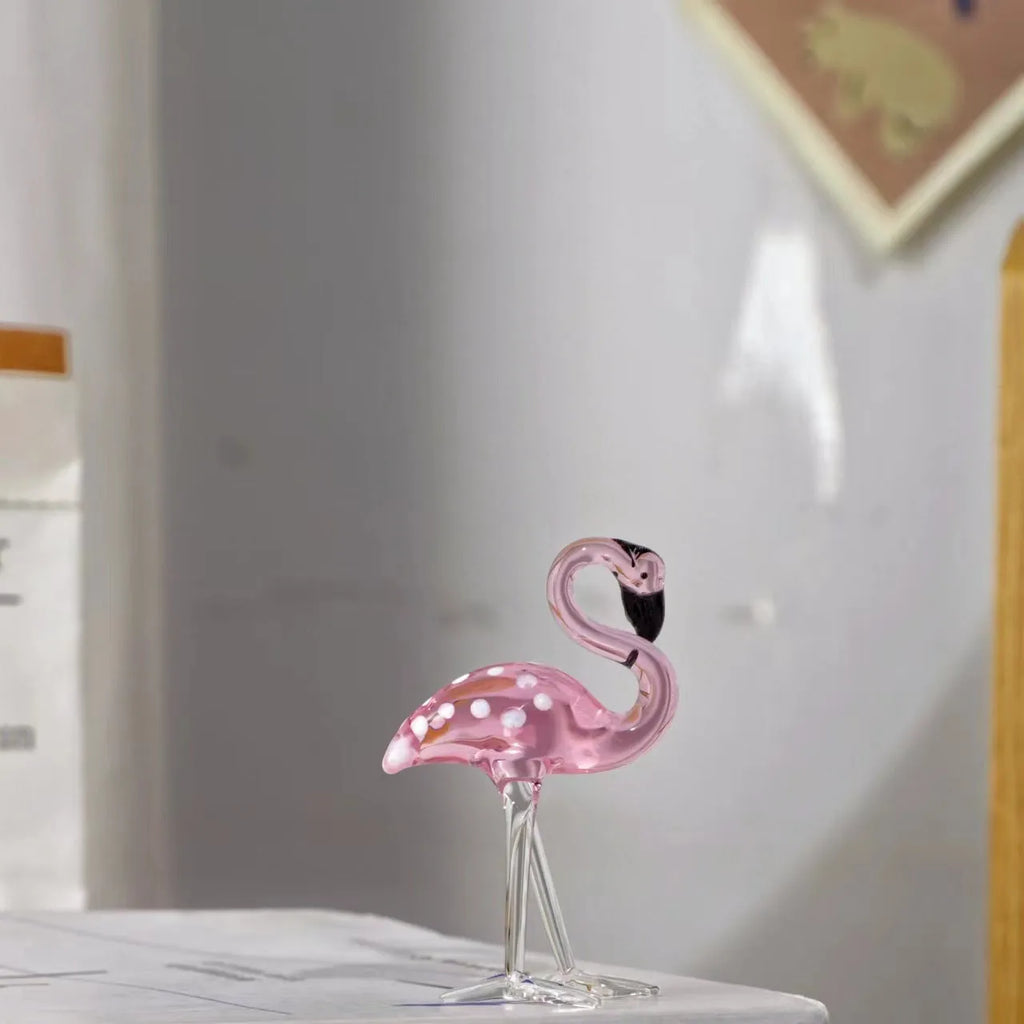 Pink crystal flamingo decorative sculpture on table with modern minimalist design
