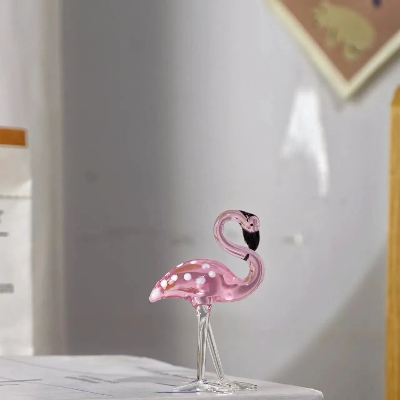 Pink crystal flamingo decorative sculpture on table with modern minimalist design