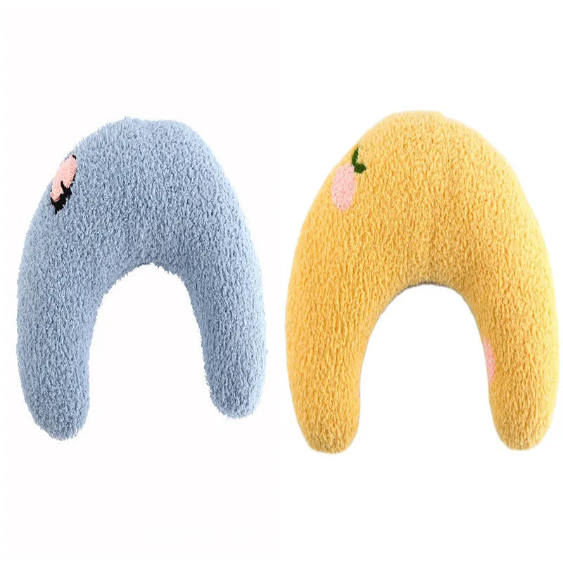 Small white U-shaped plush pet pillow for cats and small dogs on a neutral background.