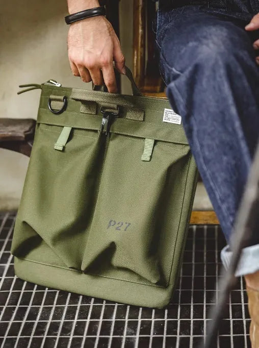 Canvas crossbody shoulder bag in military green with phone pocket and space for 15-inch laptop