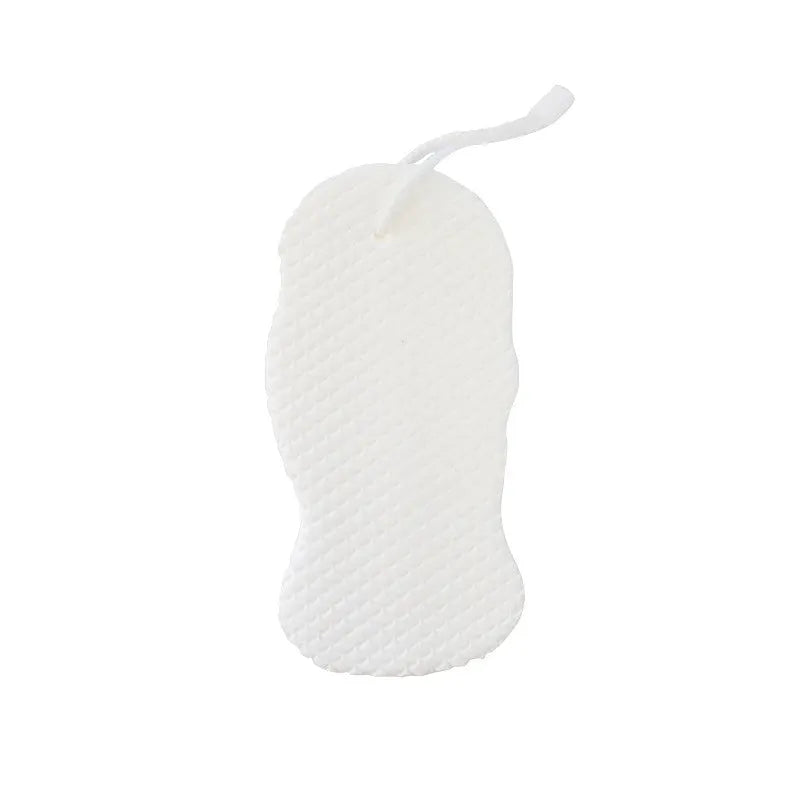 White 3D fish scale pattern bath sponge ball on a bathroom surface