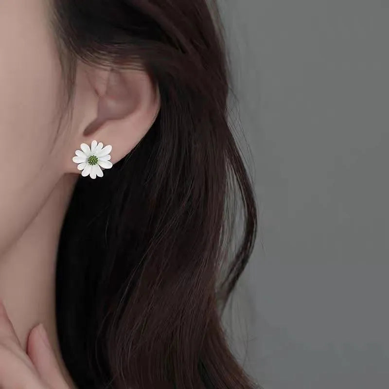 Cartoon style flower stud earrings made from alloy in blue and orange two-tone colours.