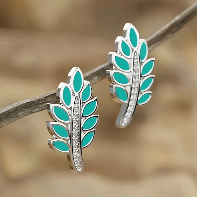 Pair of leaf-shaped copper stud earrings with white gold colour finish and inlaid zircon stone