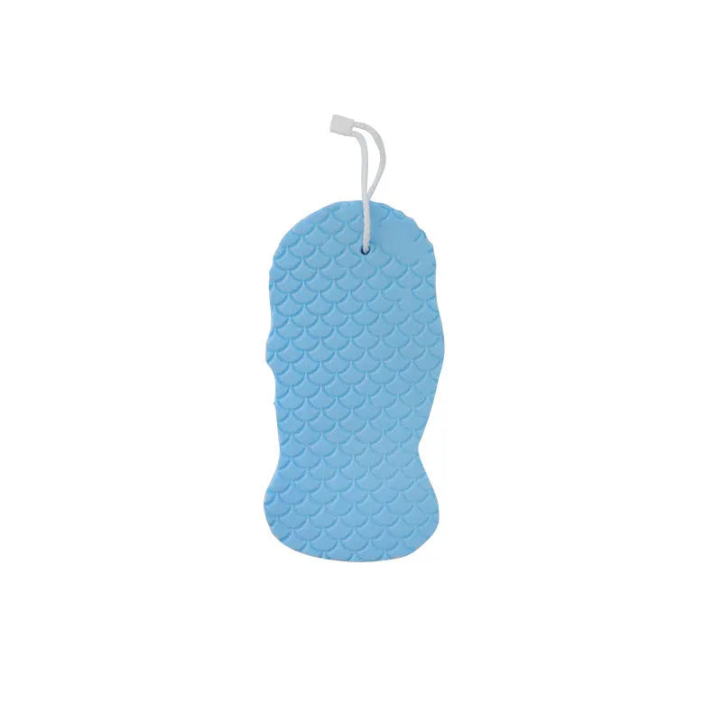 White 3D fish scale pattern bath sponge ball on a bathroom surface