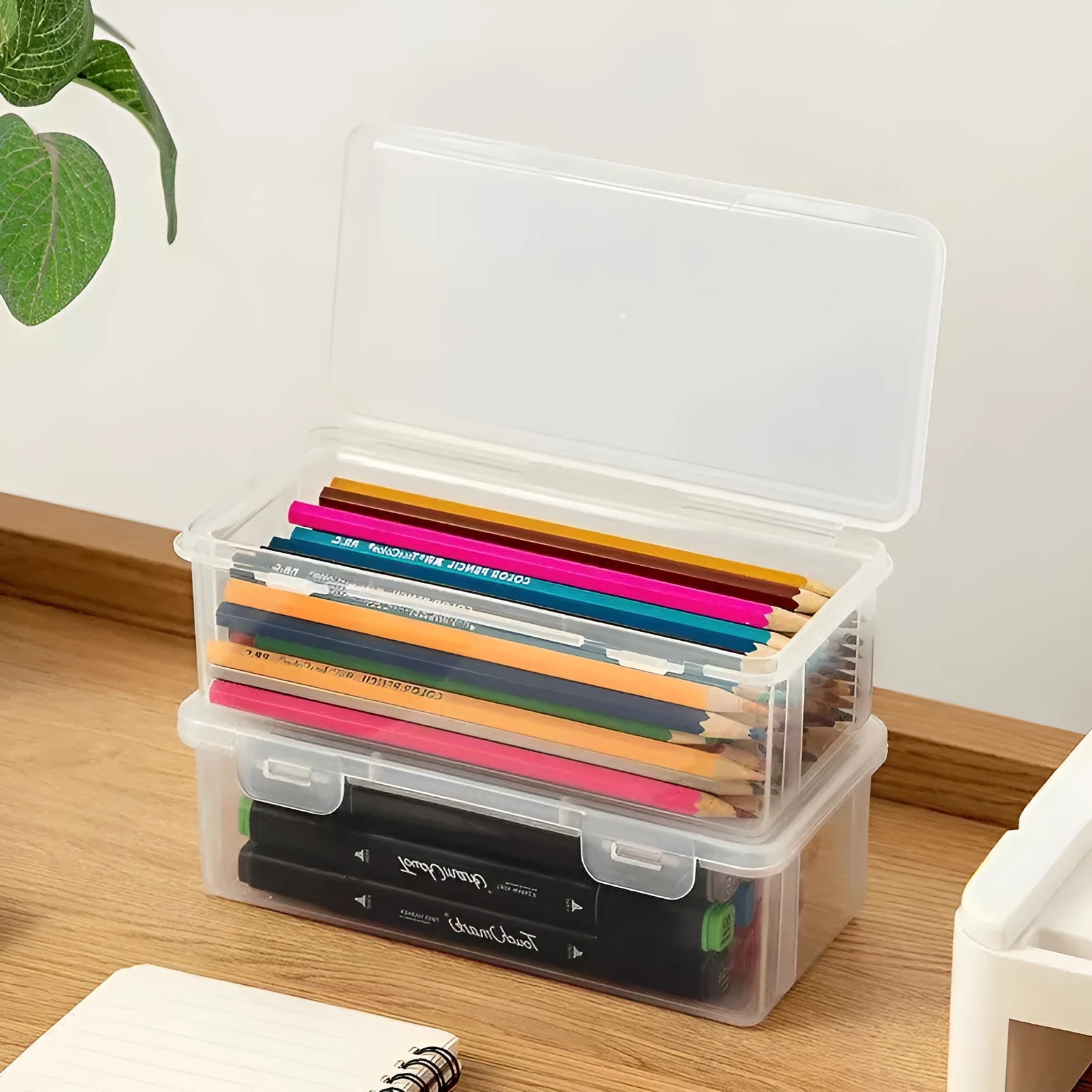 Clear plastic pencil storage box filled with coloured pencils and crayons