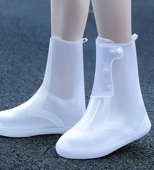 White high top PVC reusable waterproof shoe cover for women, shown on a foot.