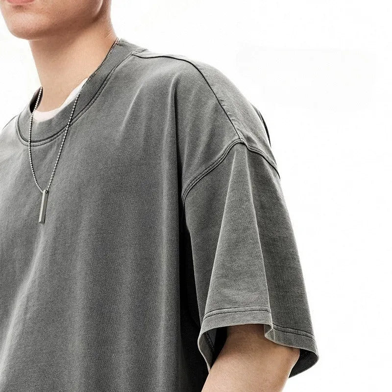 Men's cotton washed-out vintage t-shirt in khaki light showing drop-shoulder sleeve and loose fit