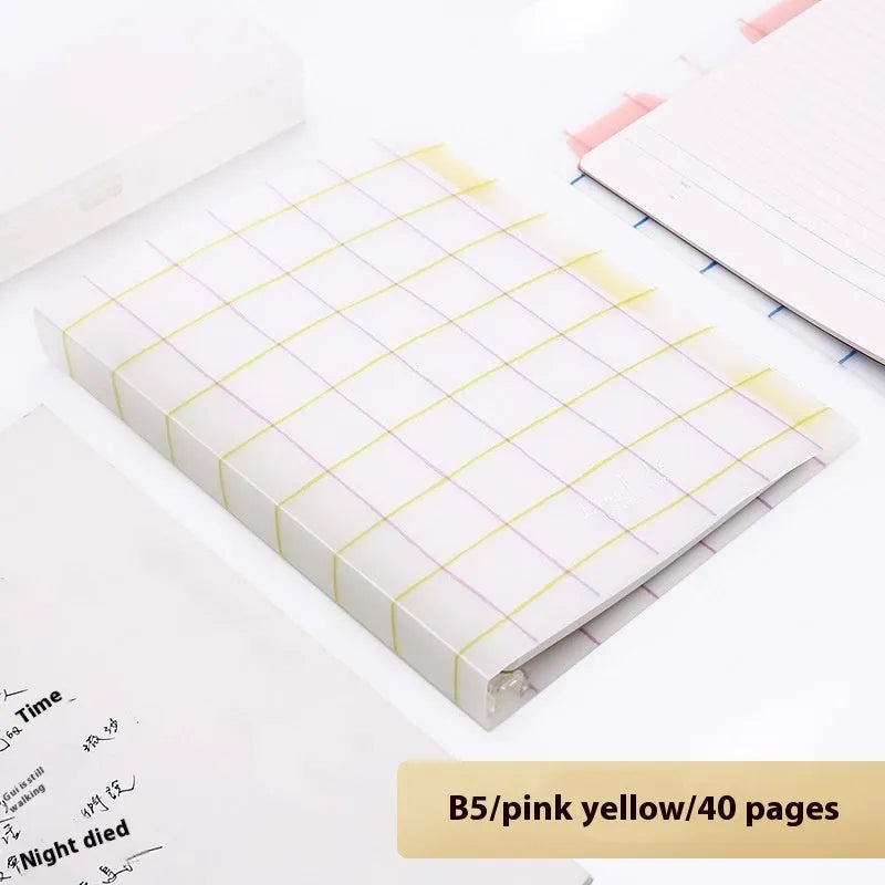 Refillable loose-leaf spiral notebook with PP cover open, showing raw wood pulp paper in grid ruling.