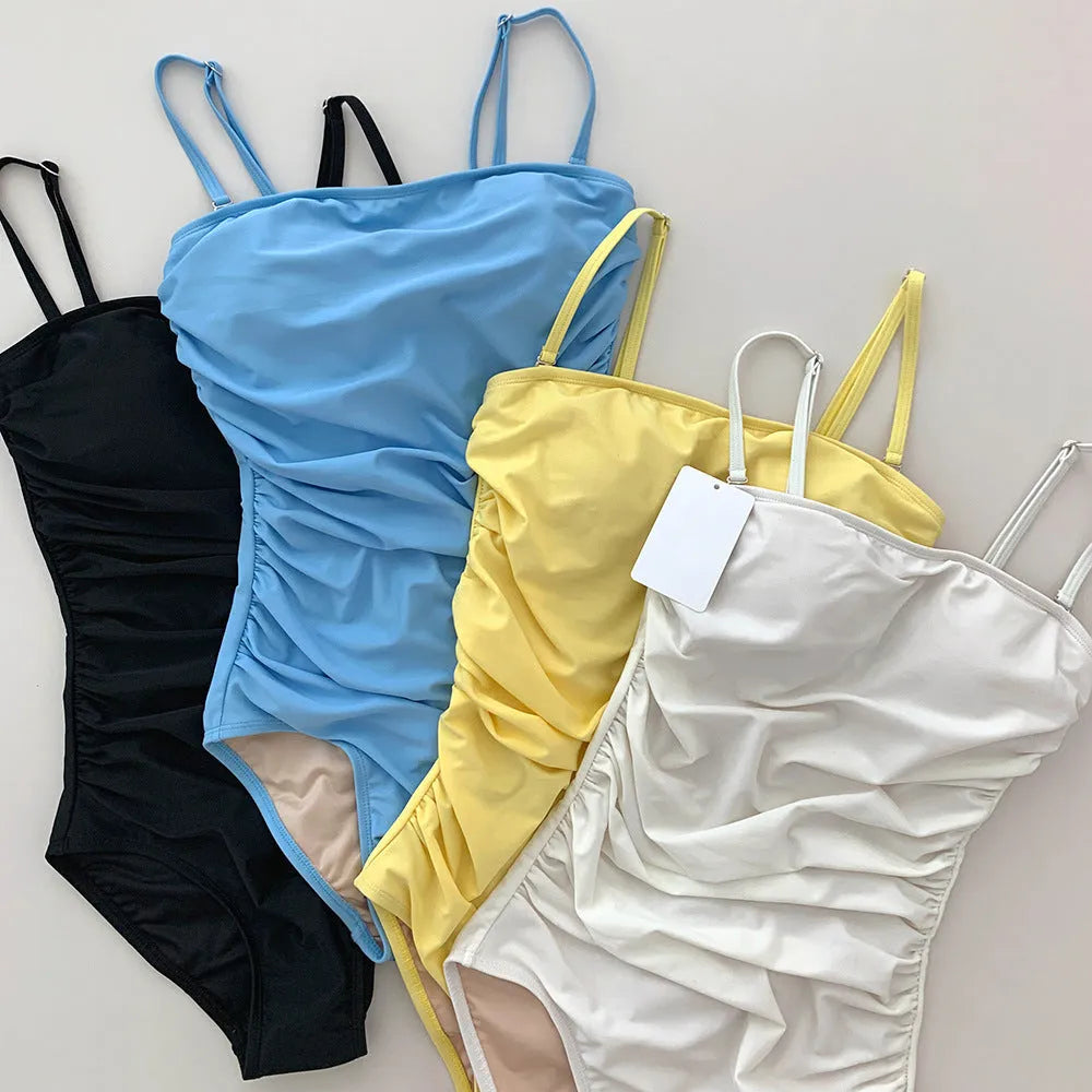 Sling style one-piece swimsuit with belly pleats in blue colour