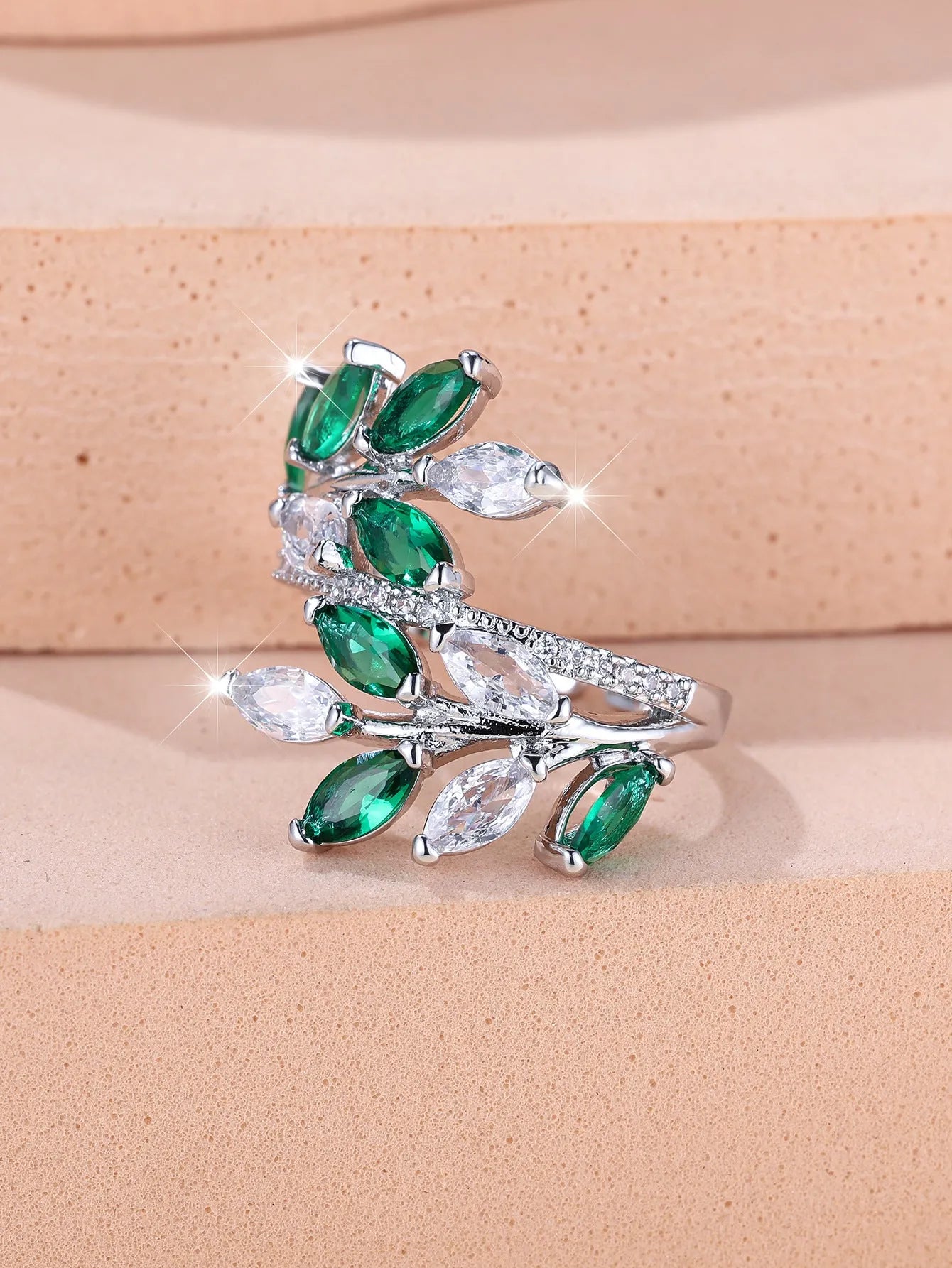 Adjustable horse eye zircon leaf ring in copper on a hand, showing leaf detail and colour options.