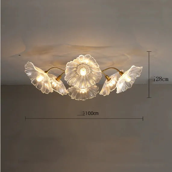 Modern white flower ceiling lamp with five light heads emitting a warm glow in a living room.