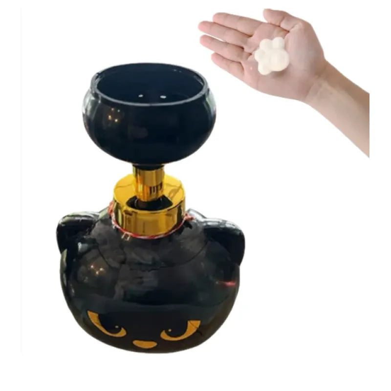 Black cartoon cat-shaped automatic foam soap dispenser on a countertop.