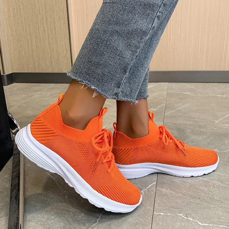 Women's mesh running shoes in Creamy White with Flyknit upper and low-top design