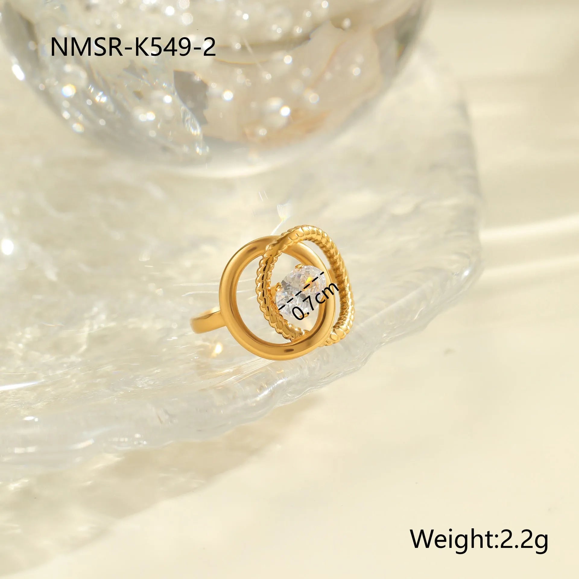Gold inlaid zircon geometric heart and drop shape stainless steel ring on white background.