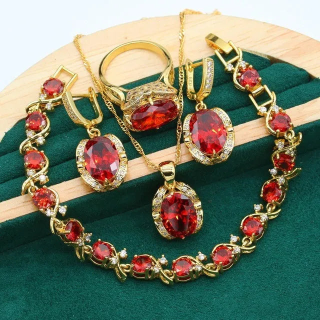 Olive green and red women's jewellery set with zircon stones, snake bone chain necklace, earrings, and ring.