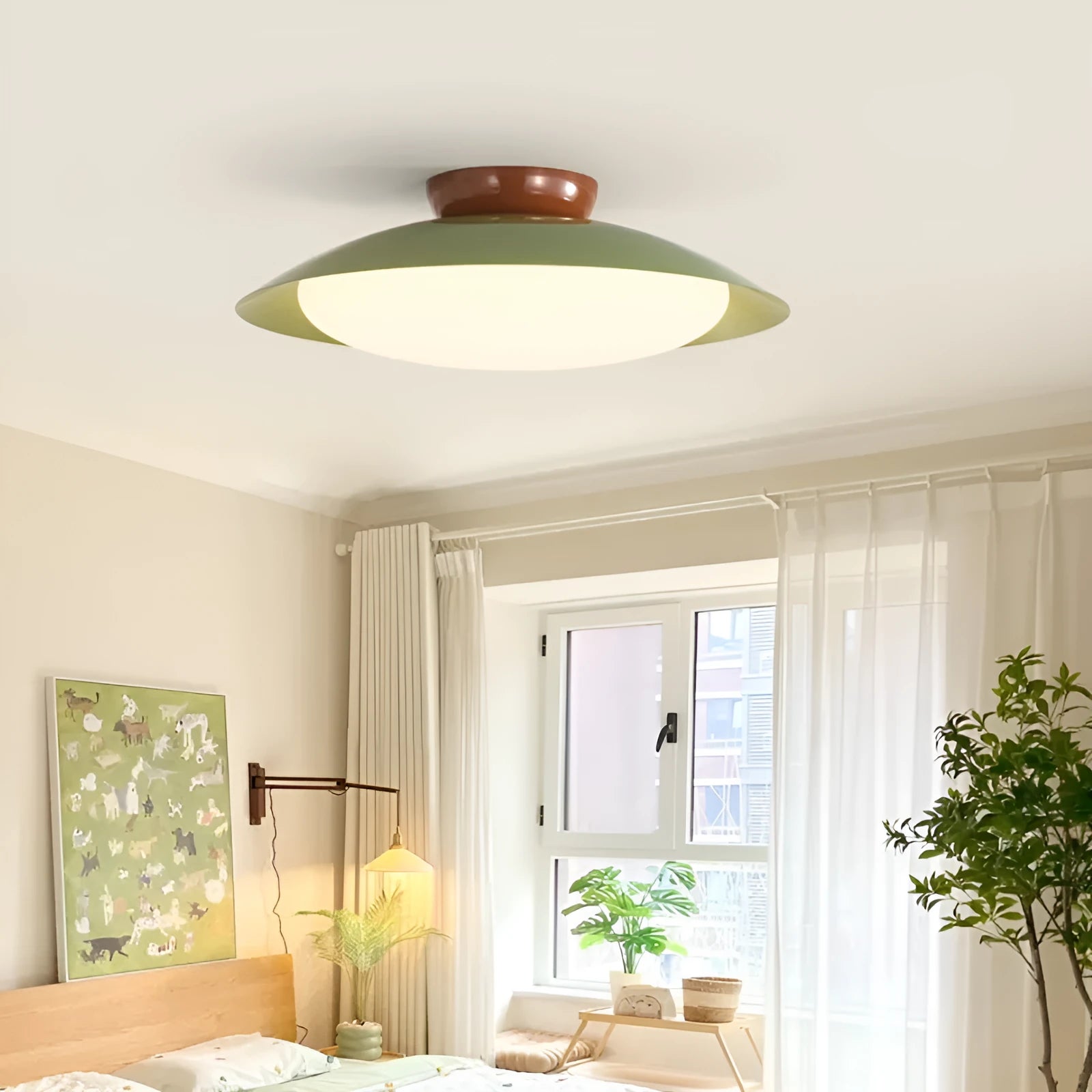 Modern cream-style flying saucer shaped ceiling lamp in a bedroom setting.