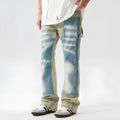 Men's yellow and blue patchwork distressed jeans with splash-ink design detail