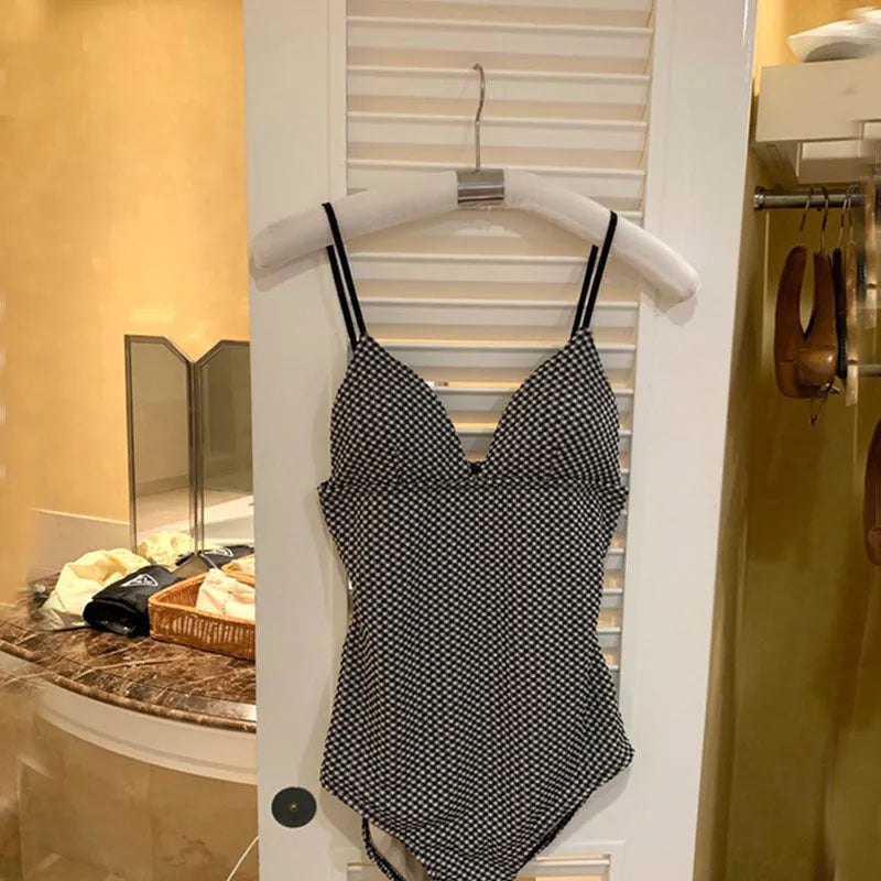 Blue thin hot spring one-piece swimsuit with belly cover and small chest design on mannequin