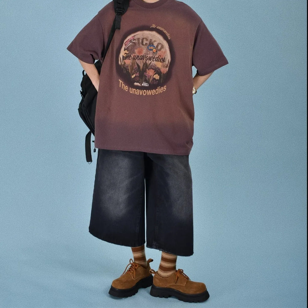 Man wearing blue loose straight-leg denim shorts with a simple summer style.