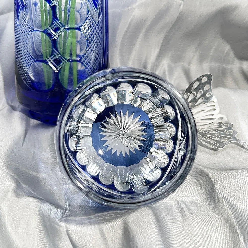 Crystal glass Jianghu Cut Zi Xinglu tumbler in violet with carved pattern on a bar surface