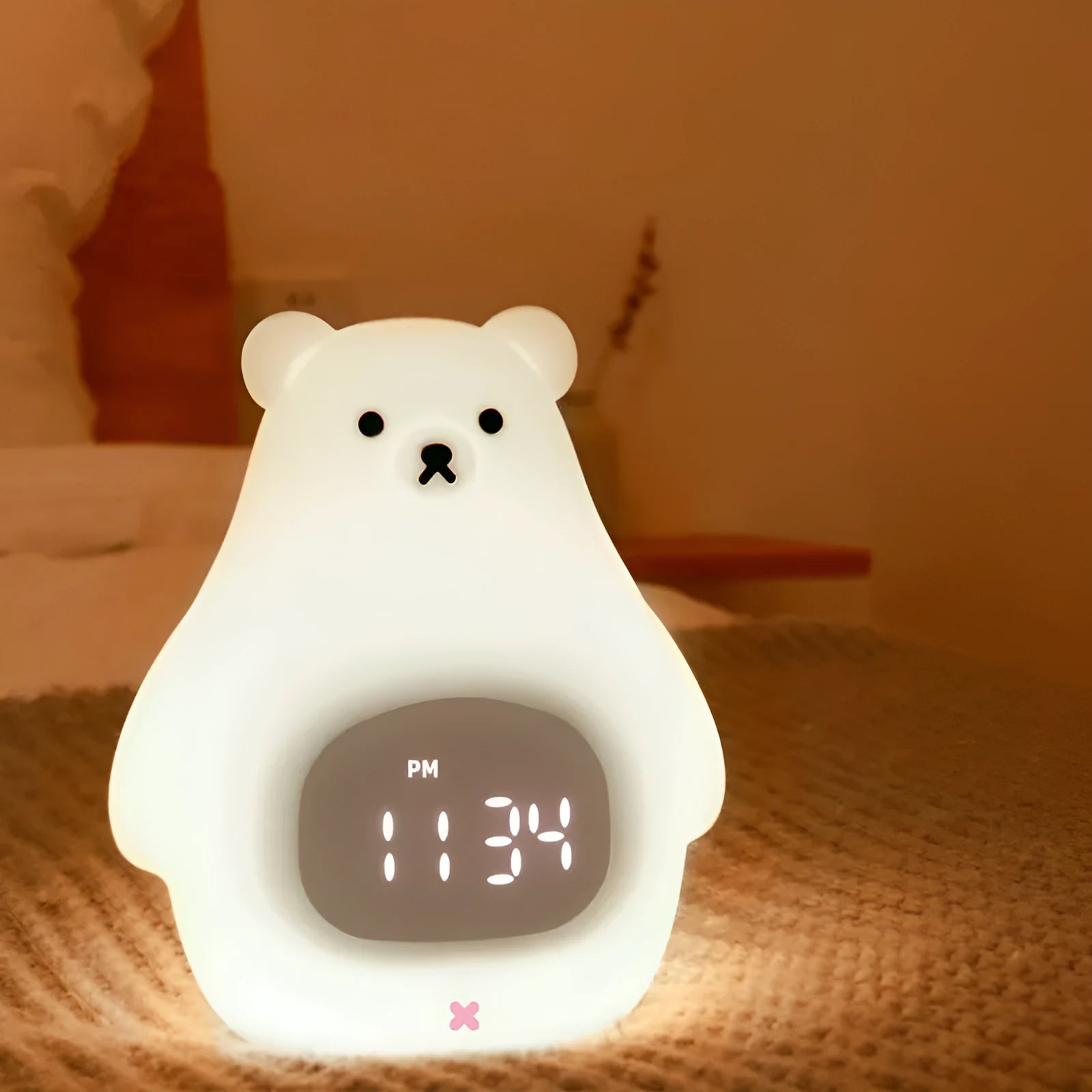 White cartoon bear silicone night light with remote control on table.
