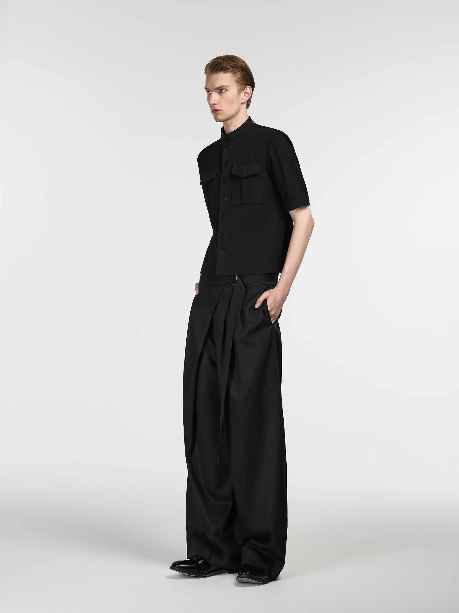Black straight-leg trousers with adjustable waistband and single pleat front detail