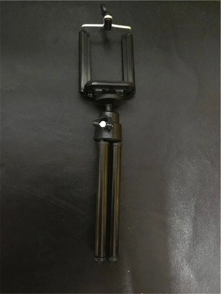 Black desktop phone holder with two-section bracket on wooden desk